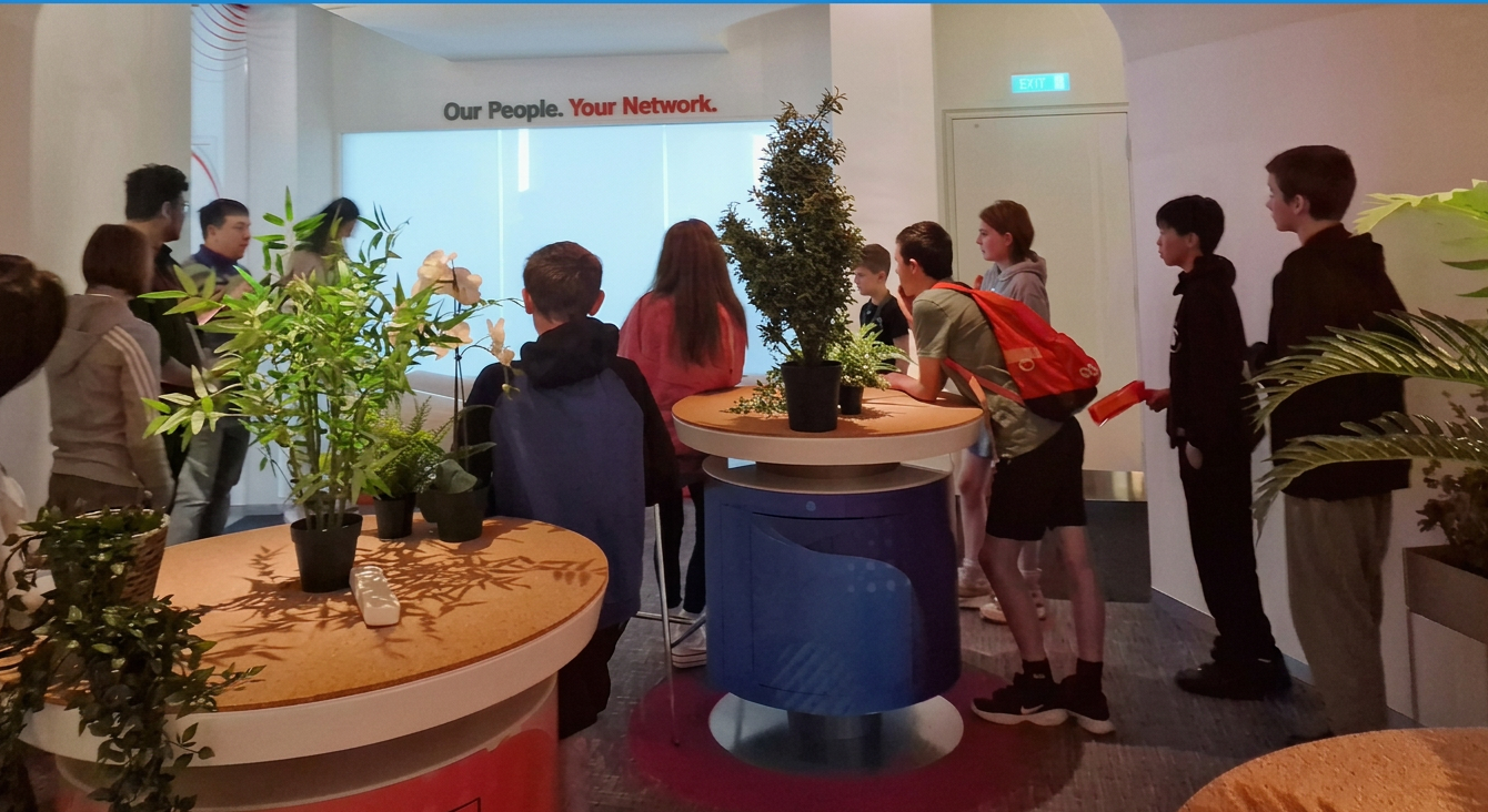 Focus group with teens gathered around interactive stations